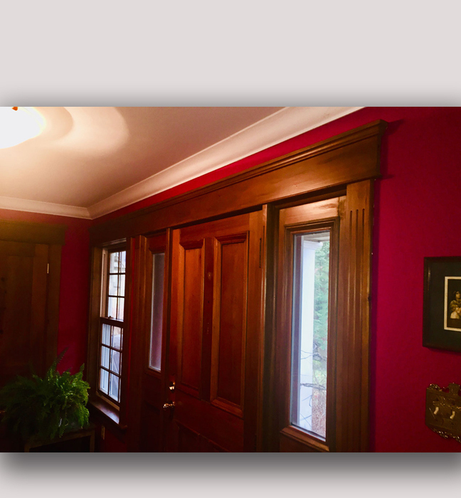 Mahone Bay, NS foyer: Deep fuchsia walls colour-matched to a fabric wall hanging. Woodwork enriched with tinted clear coat.